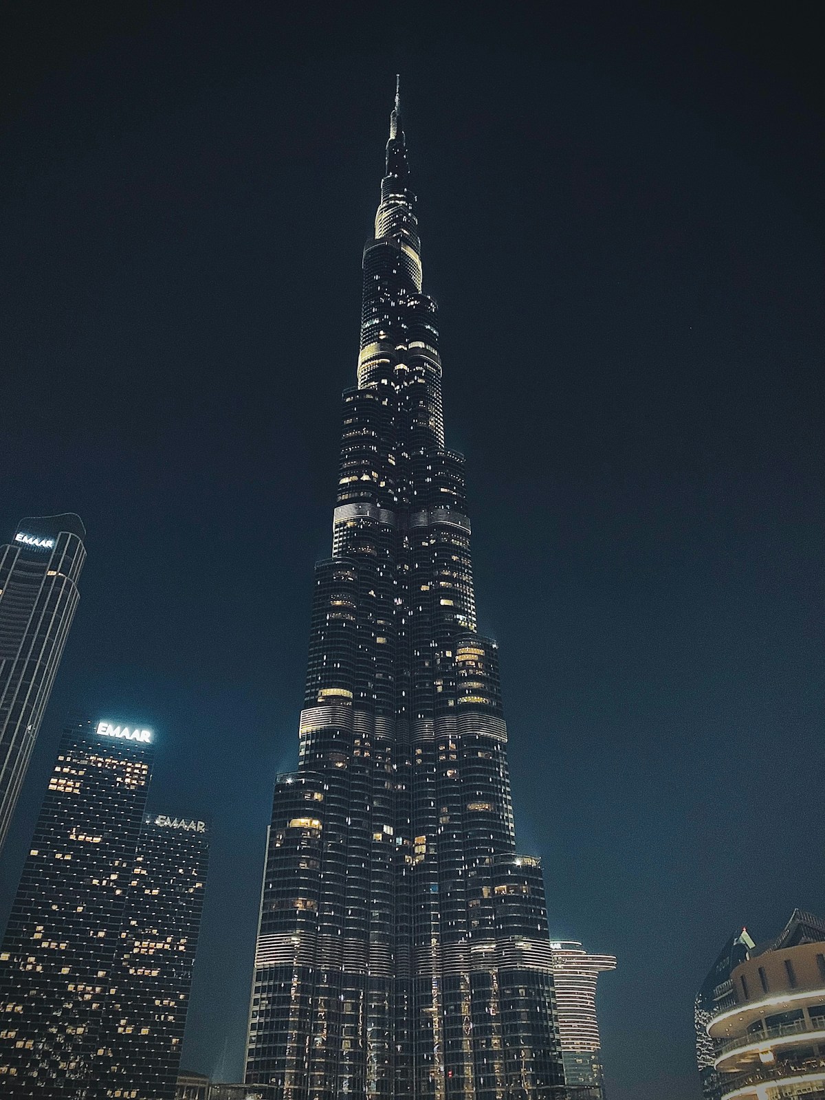 Burj Khalifa towering at night over the illuminated Dubai skyline UAE