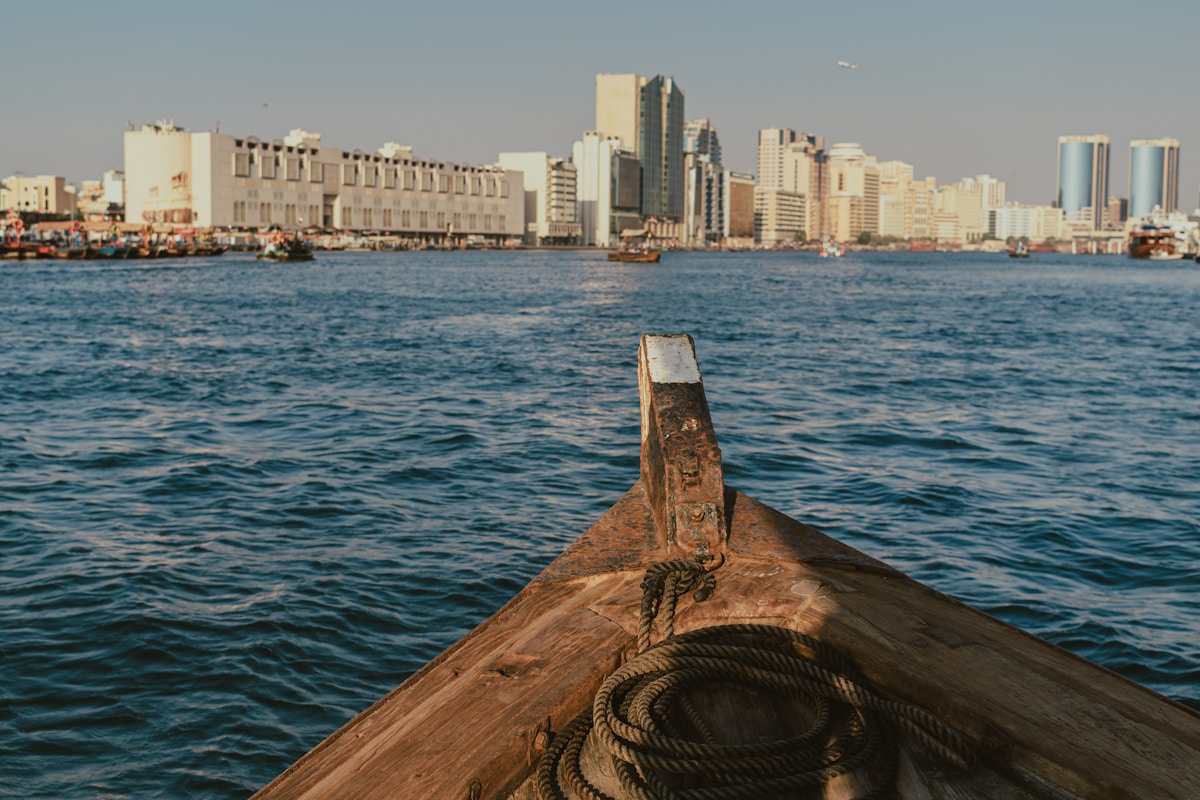 View of Dubai Creek waterfront from a traditional wooden abra boat