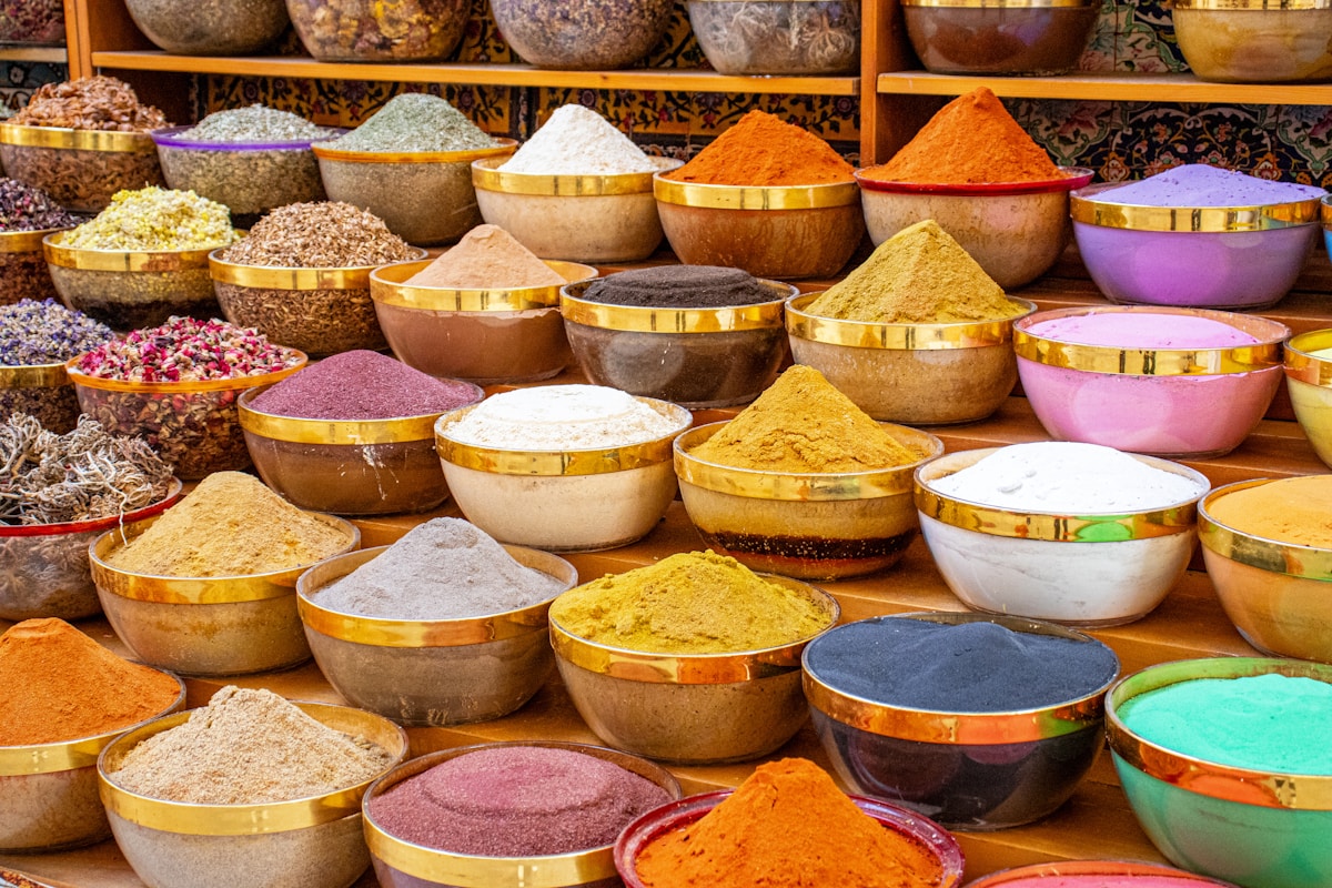Colorful spice display in golden bowls at Deira Spice Souk, Dubai