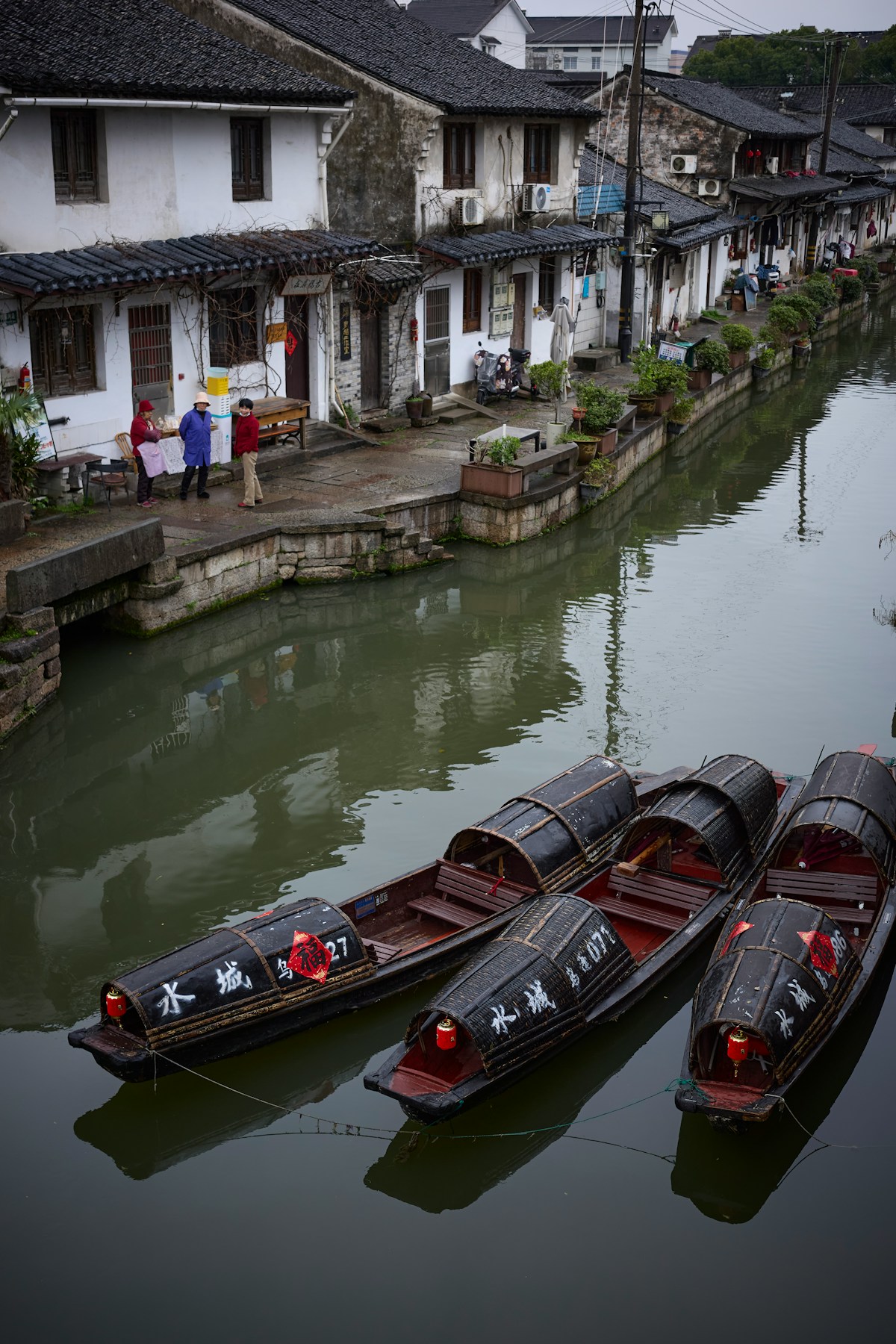 Boats docked along a canal beside traditional buildings UAE