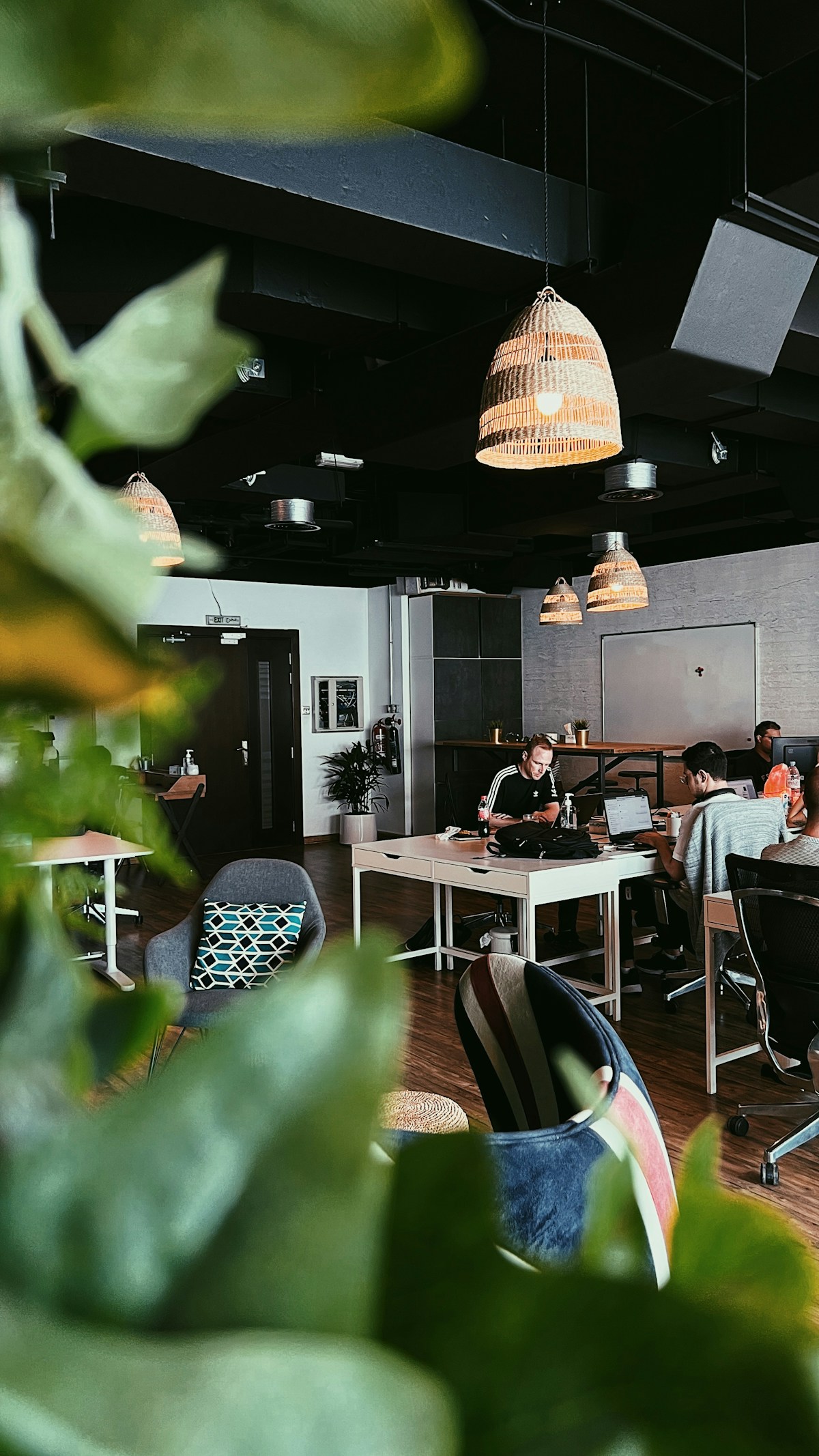 People working on laptops at a café table, remote work coworking Dubai UAE