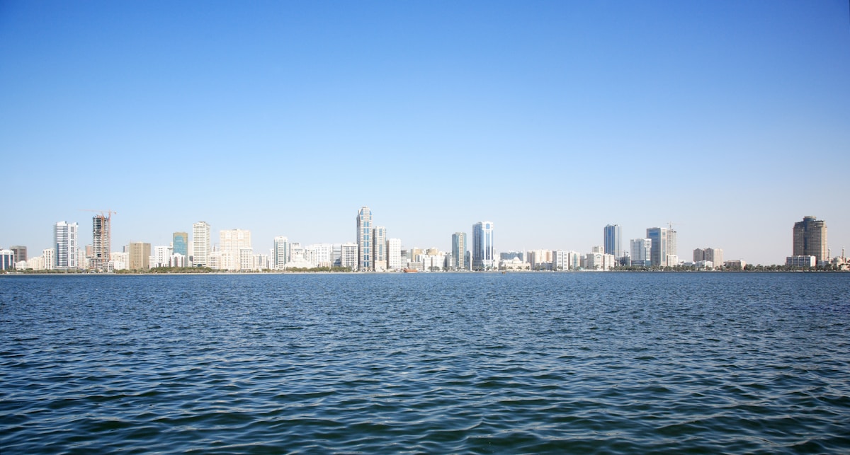 Sharjah city skyline reflected in the calm waters of Khalid Lagoon, UAE
