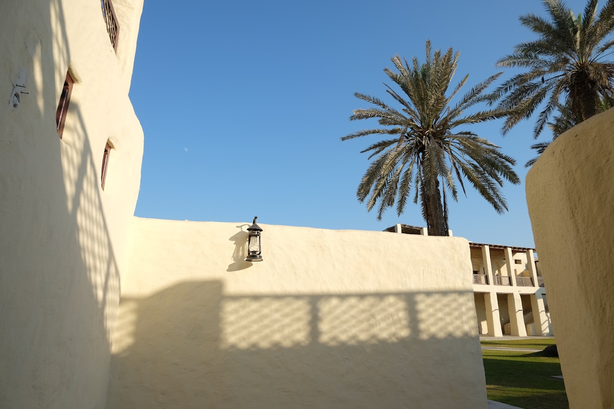 Historic Umm Al Quwain Fort with white walls and palm trees, UAE