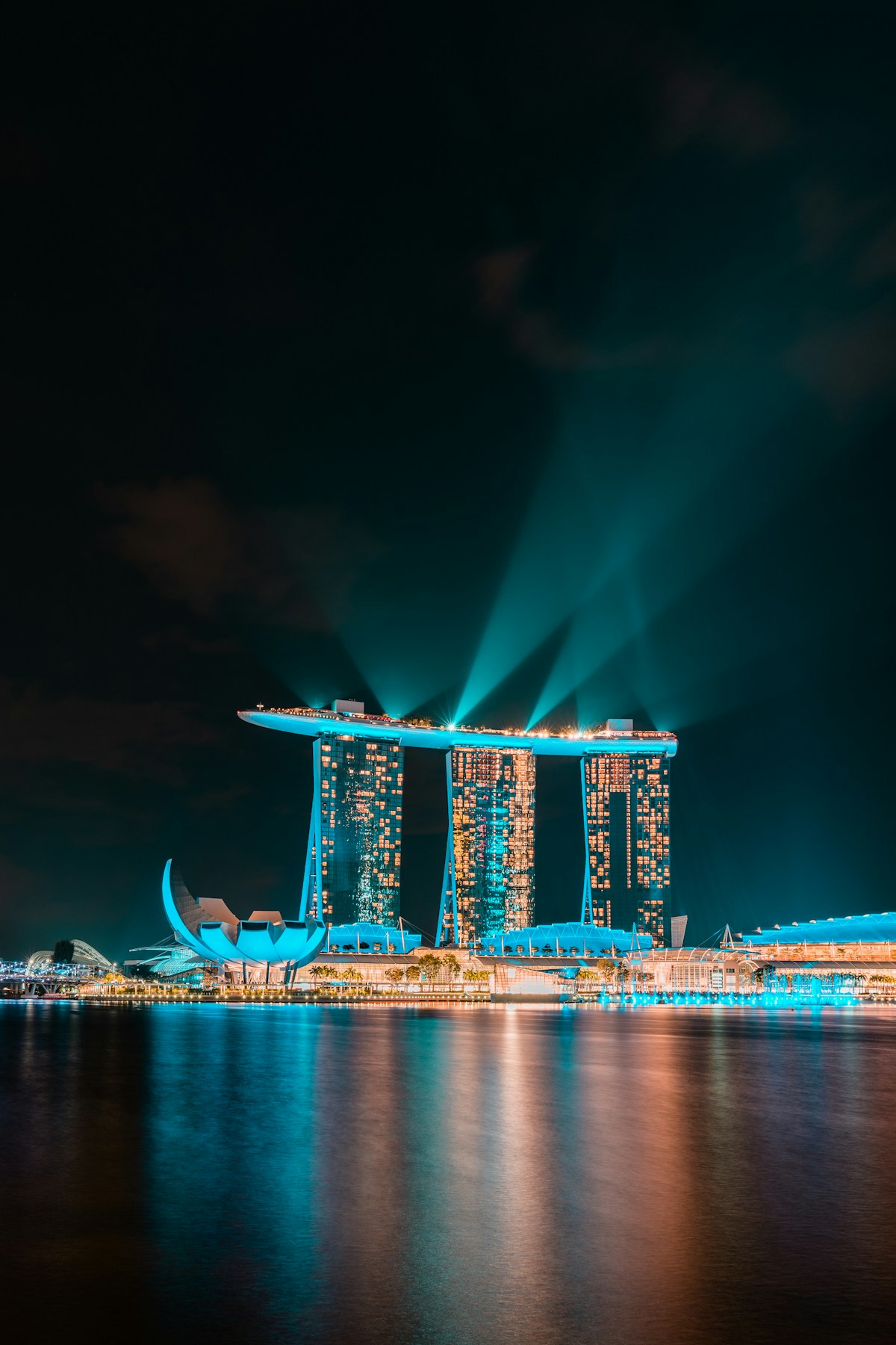 Marina Bay Sands hotel illuminated at night with Singapore skyline