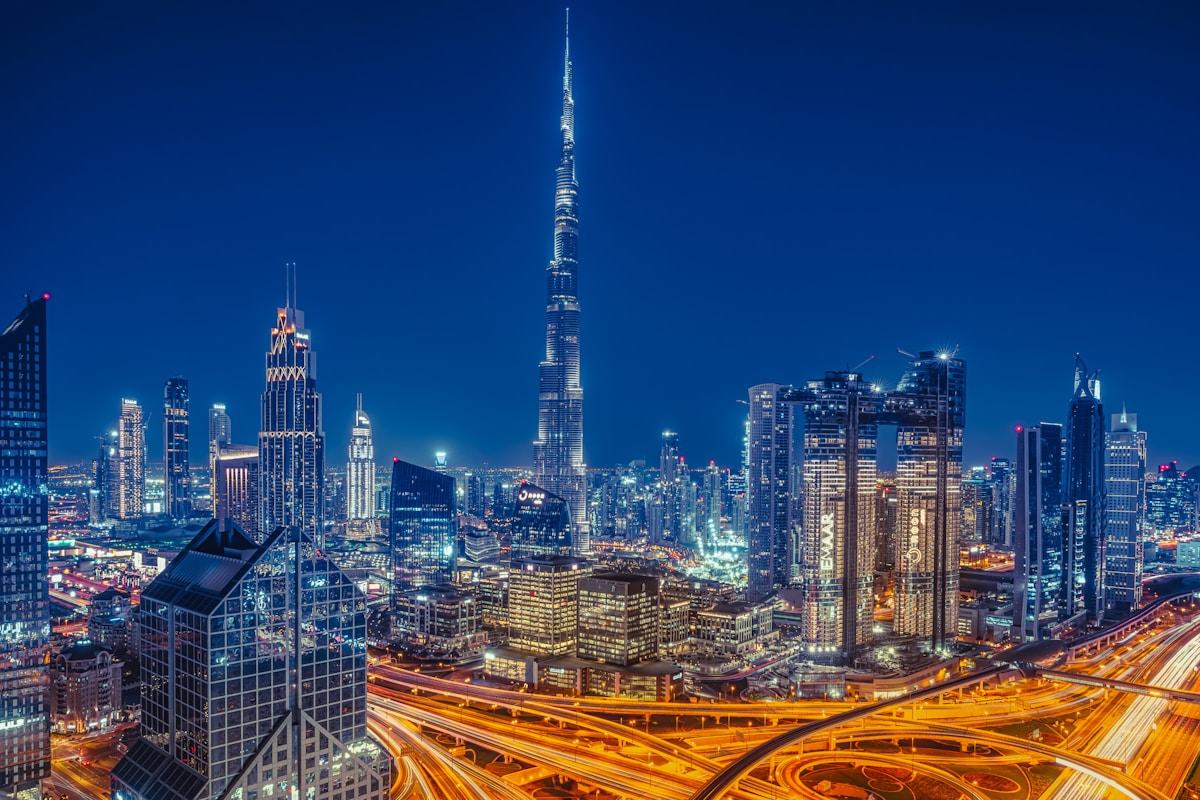 Dubai city skyline at night with Burj Khalifa illuminated, United Arab Emirates