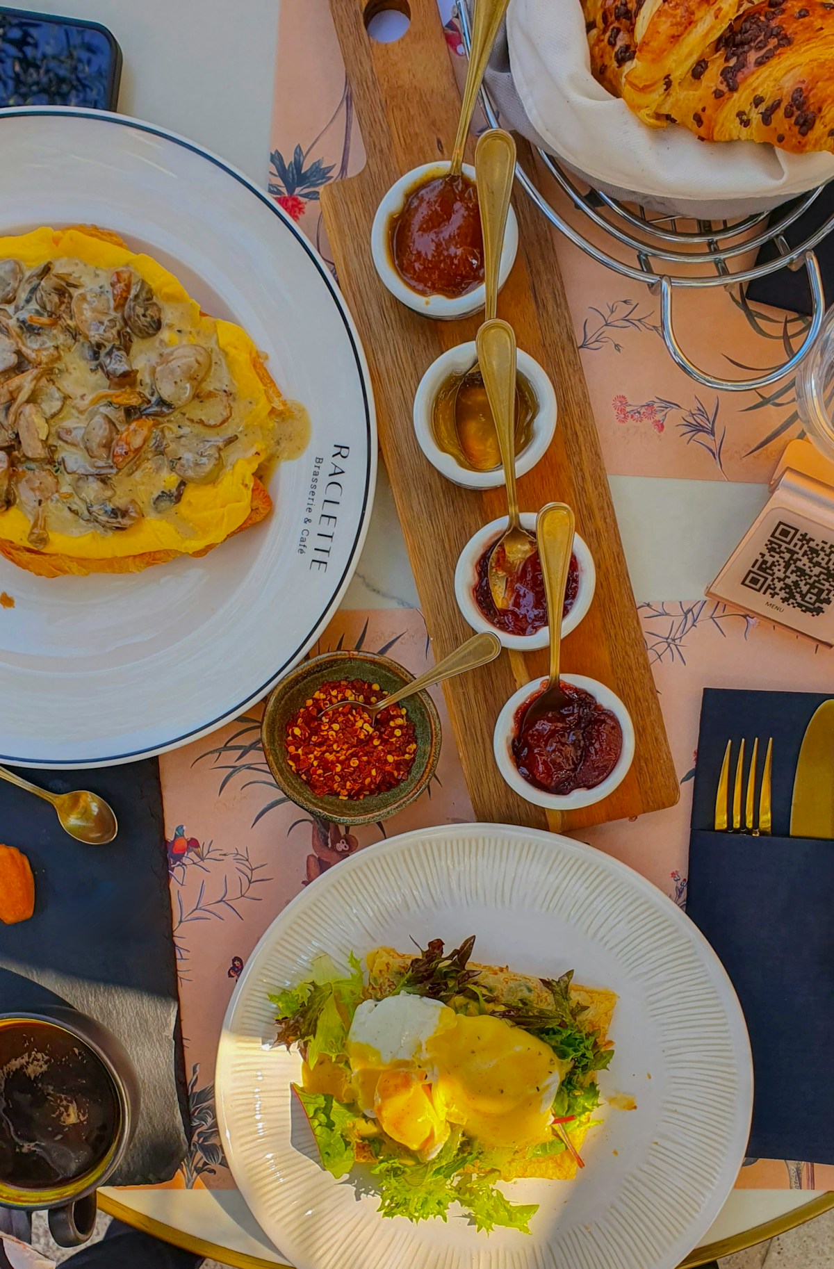 Restaurant dishes including raclette and eggs benedict on a table in Abu Dhabi, UAE