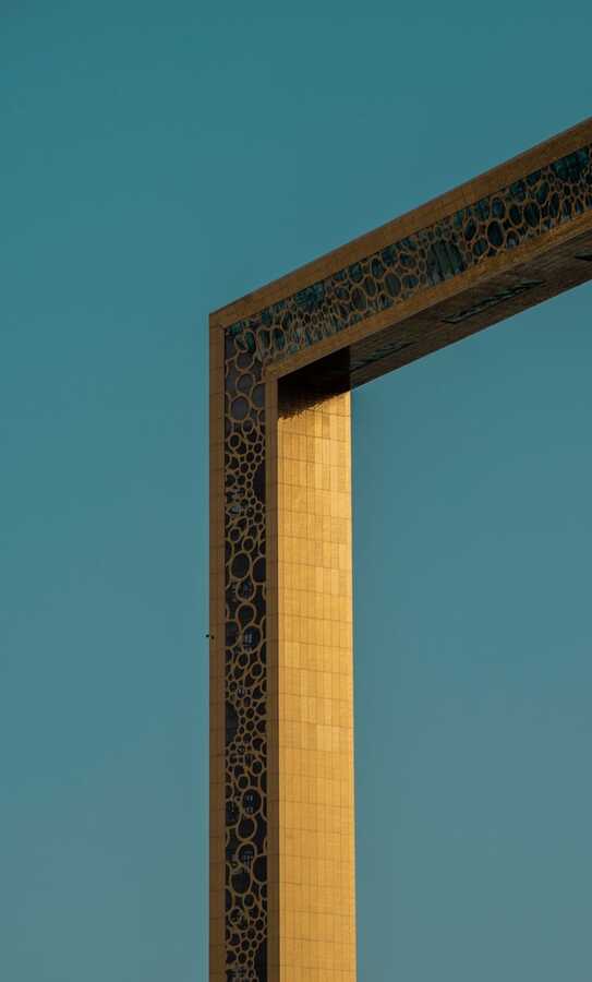 Edge of the golden Dubai Frame against a teal sky