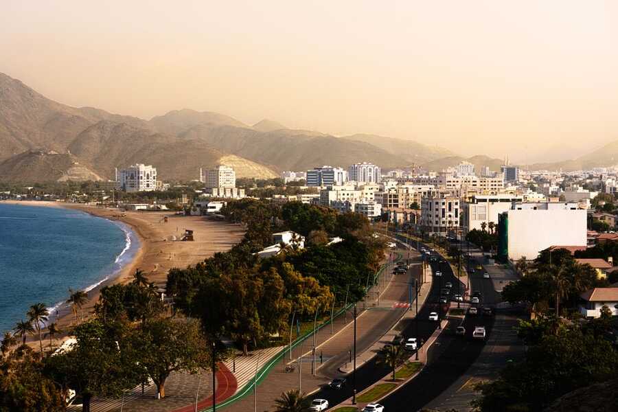 Beach, coastal road and mountains on the UAE east coast near Khor Fakkan