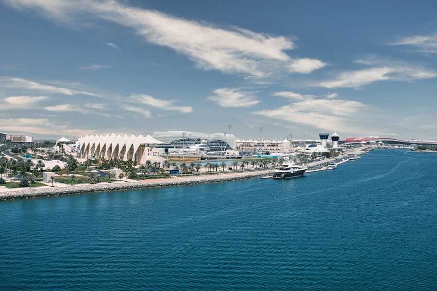 Yas Island waterfront with the Yas Marina Circuit buildings and blue water