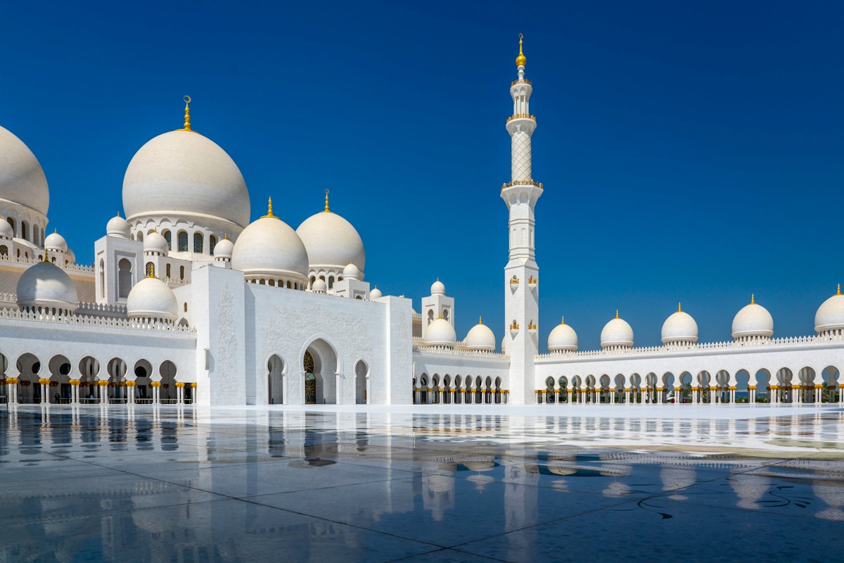 Sheikh Zayed Grand Mosque white and gold dome under clear blue sky, Abu Dhabi UAE