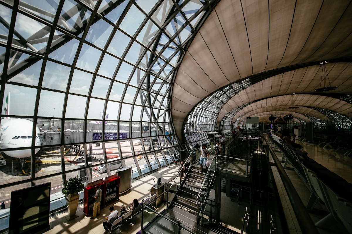 Travellers walking through a busy international airport terminal