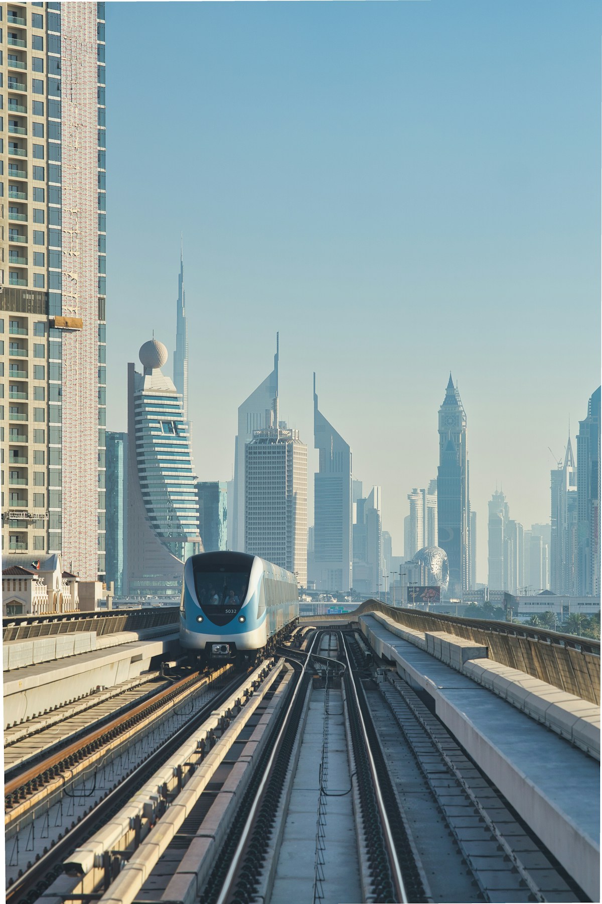 Dubai Metro train travelling between modern skyscrapers, UAE