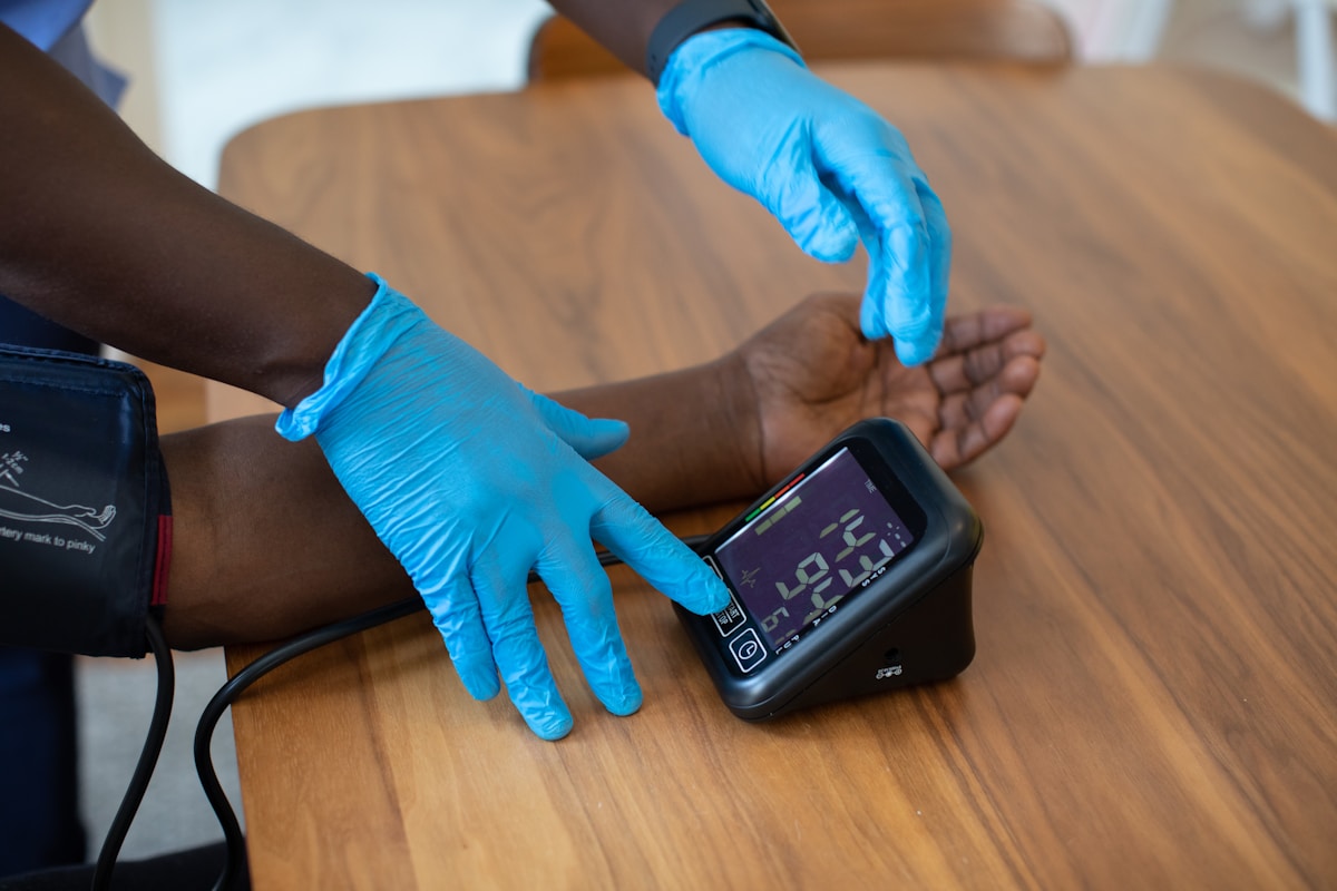 Person using touchscreen medical device representing travel health insurance