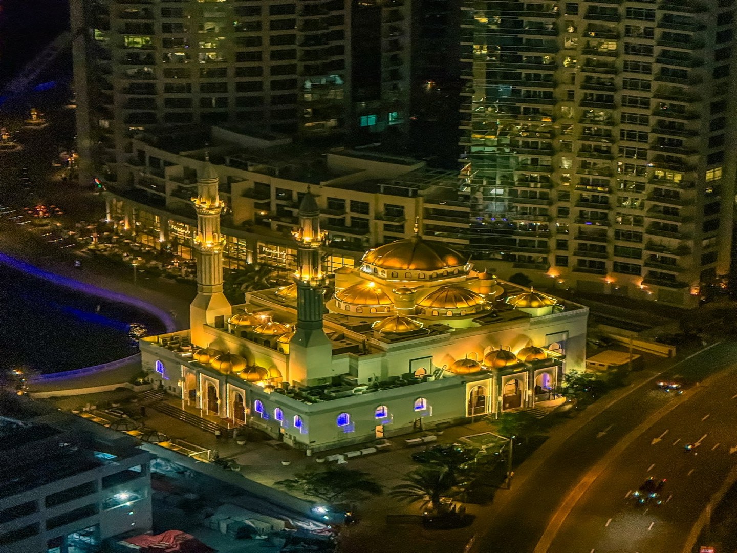 Golden mosque illuminated at night in Dubai, UAE