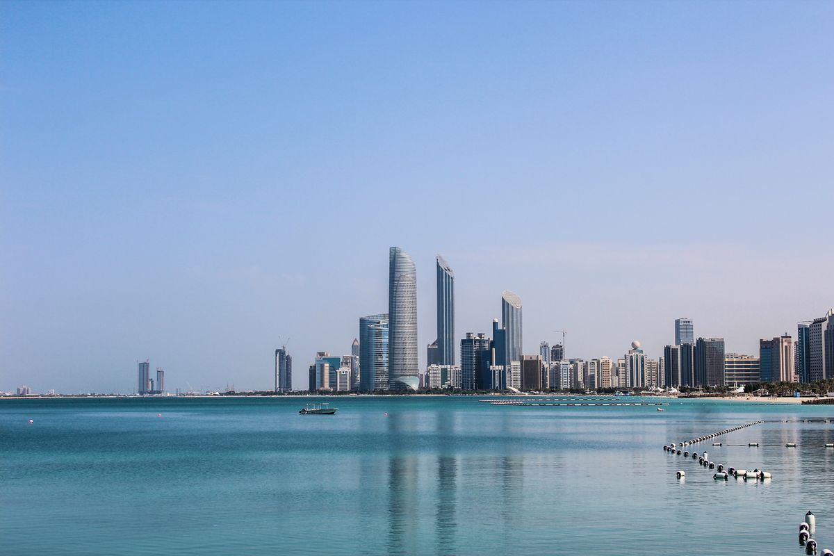 Abu Dhabi skyline across calm water on a clear day