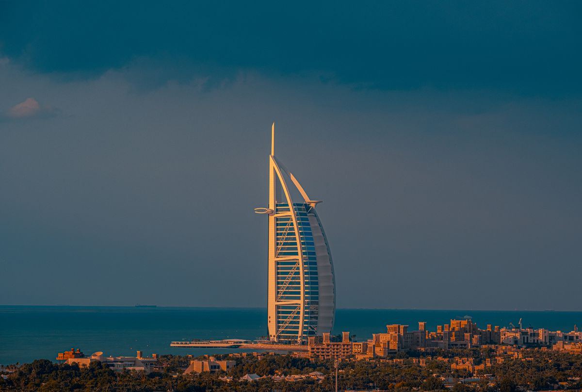 Burj Al Arab rising over the Dubai coastline at dusk