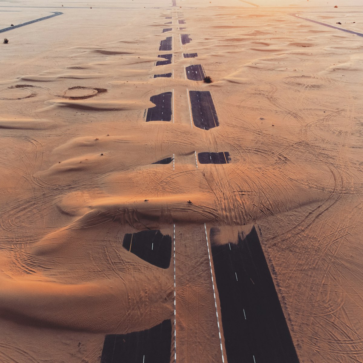 Aerial view of a desert highway in Dubai, UAE at sunset
