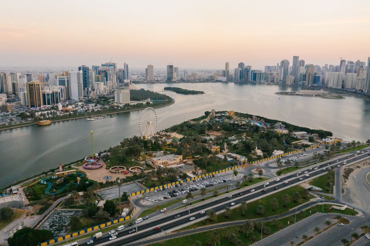 Aerial view of Sharjah waterfront and city at sunset
